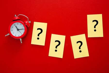 a question mark a red alarm clock . FAQ frequency asked questions, Answer and Brainstorming Concepts
