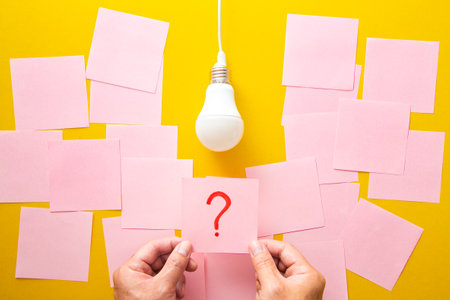 The process of problem solving. Question mark and light bulb on yellow background.
