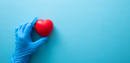 Hand in medical glove hold red heart sign. Health care, charity, donation conceptの写真素材