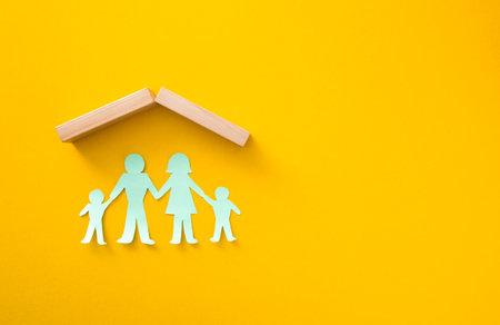 Life insurance concept. Paper cutout of family (father, mother, son and daughter)の写真素材