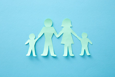 Life insurance concept. Paper cutout of family (father, mother, son and daughter)の写真素材