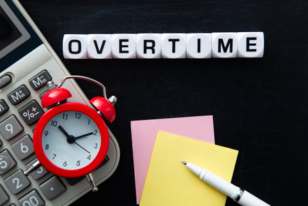 Clock, Calculator and Overtime Word on black background. Overtime work concept.