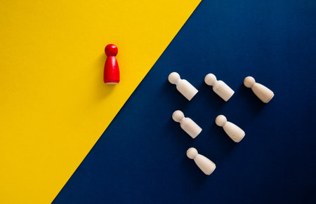 Red pawn standing out from the group of white pawns, representing leadership, different approach, and unique business strategyの写真素材