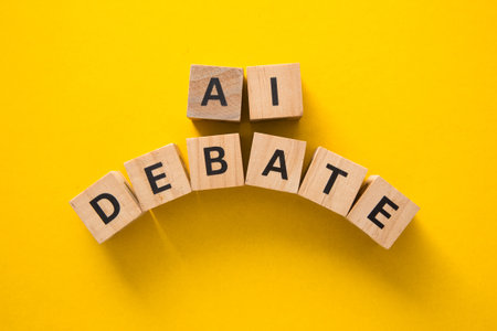 Wooden cubes composing the words ai and debate, representing discussion and controversy surrounding...