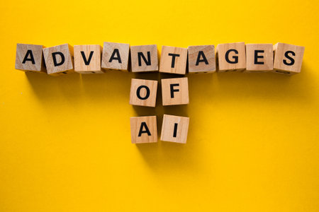 Wooden cubes spelling advantages of ai represent the positive aspects of artificial intelligence on a vibrant yellow backdropの写真素材