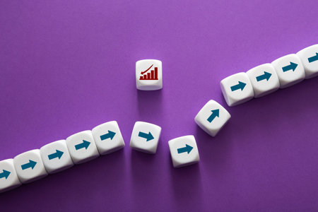 Dice showing a bar chart icon and moving in various directions with arrows representing growth