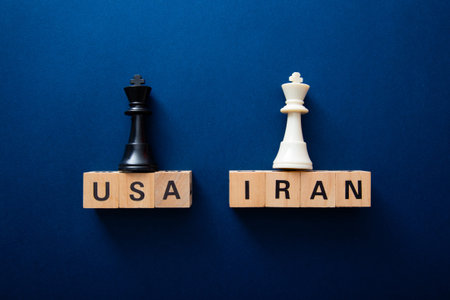Usa and iran chess kings symbolize international strategy and conflict on a blue backgroundの写真素材