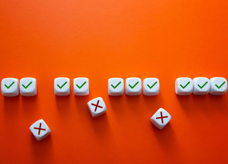 White cubes displaying green checkmarks and red crosses on an orange background