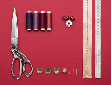 Sewing tools on red backgroundの写真素材