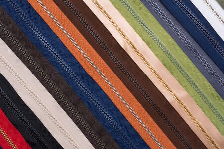 Closeup of zippers of different colors in lineの写真素材