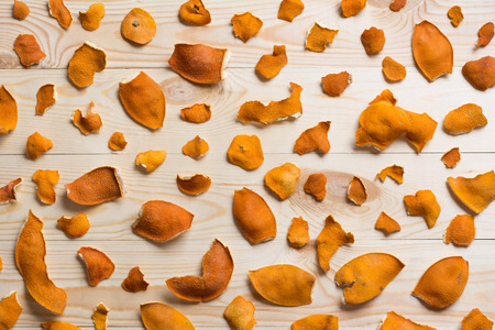 Dry orange peels texture on wooden tableの写真素材