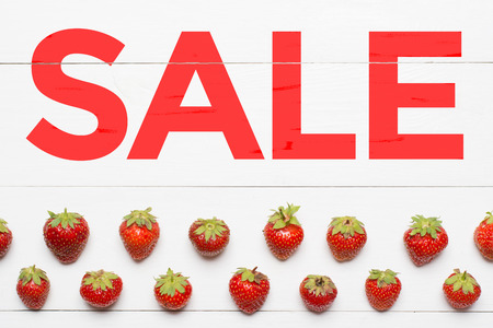 Word Sale painted on white wooden desk. Strawberry patternの写真素材