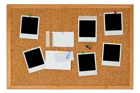 Cork board with blank instant photos and notes isolated on a white background