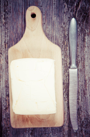 Butter on a wooden chopping boardの写真素材
