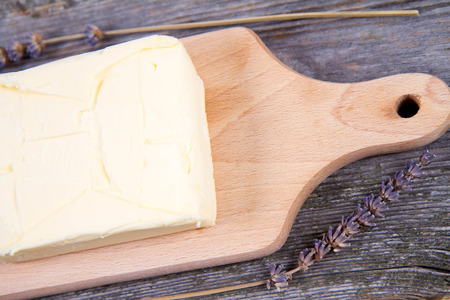Butterfly on a wooden chopping board decorated with lavenderの写真素材