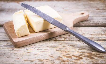 Butterfly on a wooden chopping board with a knifeの写真素材