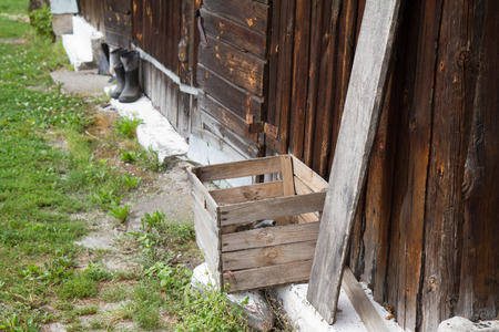 Wooden barn with rubber-soled felt boots standing in front of itの写真素材