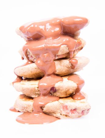 Pancakes with apples being covered with chocolateの写真素材
