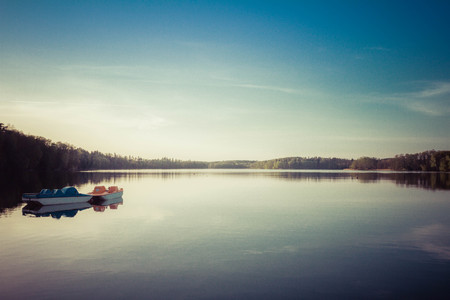 Pedal boats on a Lake at sunsetの写真素材