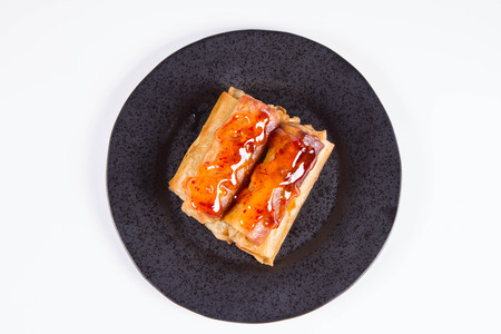 Chinese Traditional Spring rolls with sweet and sour sauce on a black plateの写真素材