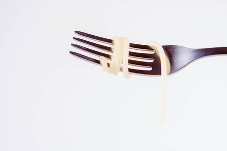 A single cooked spaghetti on a forkの写真素材