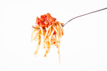 Spaghetti bolognese on a fork on a white backgroundの写真素材
