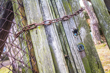 Rusty chain on an old wooden gate