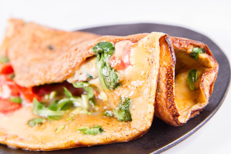 Omelette with tomatoes and fresh corn salad on a white backgroundの写真素材