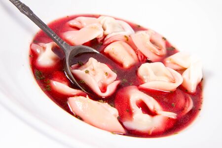 Polish Christmas Eve dish: clear borscht with dumplings (uszka) eaten with a spoonの写真素材