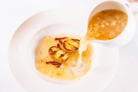 Sauerkraut (sour cabbage) soup with smoked rib and roasted potatoの写真素材