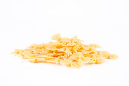 Raw Farfalle pasta on a white background