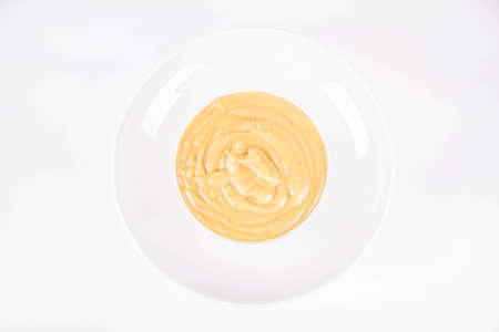 Pumpkin soup on a plate on a white backgroundの写真素材