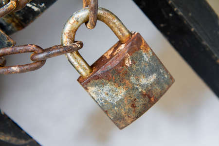 A gate closed with a padlock - focus on the padlock