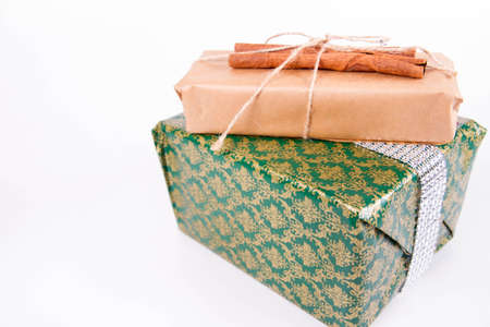 Gift boxes wrapped in craft paper and tied with twine on white backgroundの写真素材