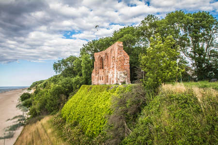 A panoramic view of the ruins of a medieval church on the shores of the Baltic Sea.の写真素材