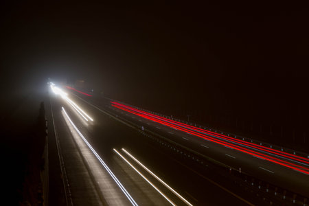 Car light trails on the road at night. Long exposure photo.の写真素材