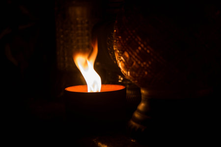 Burning candle in a dark room. Selective focus. Shallow depth of fieldの写真素材