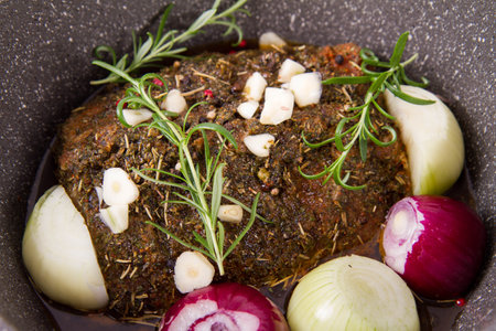 Meatloaf with rosemary, onion and spices in a frying panの写真素材