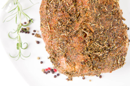 Beef steak with herbs and spices on a white plate closeupの写真素材