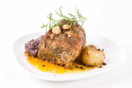 roast meat with sauce on a white background in the restauranteの写真素材