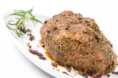 baked meat with spices on a white background in the restaurant kitchenの写真素材