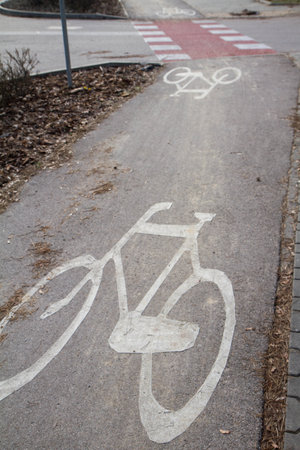 Bicycle path with white bike symbol painted on itの写真素材