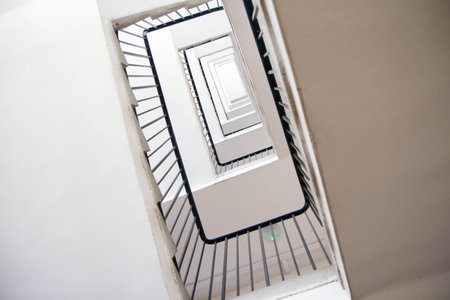Staircase in an apartment building with metal railing seen upwardsの写真素材