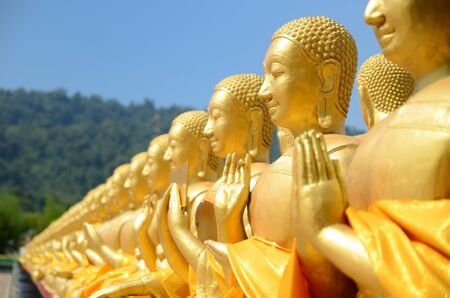 Golden Buddhist saint statues at Buddha Memorial parkの写真素材