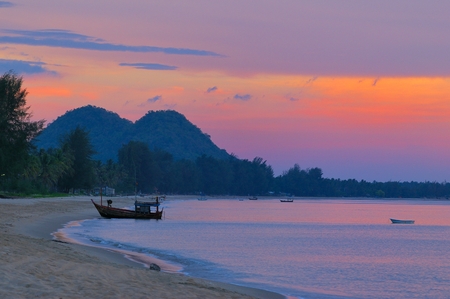 Boat on the beach at sunriseの写真素材