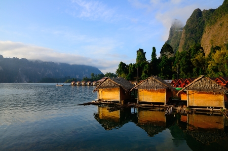 Huts and the relection at Ratchaprapa dam, Thailandの写真素材