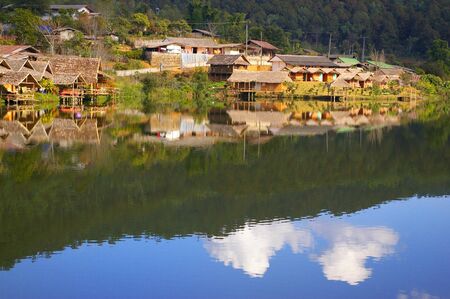 Village with reflection on the riverの写真素材