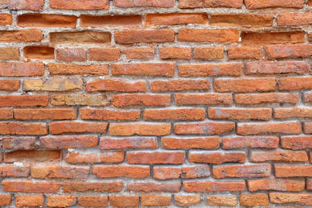 Cracked worn red brick wallの写真素材