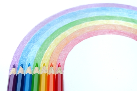 Colored pencils with  hand drawing of rainbowの写真素材