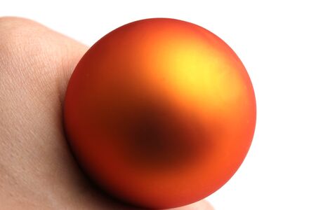 orange sphere in a handの写真素材